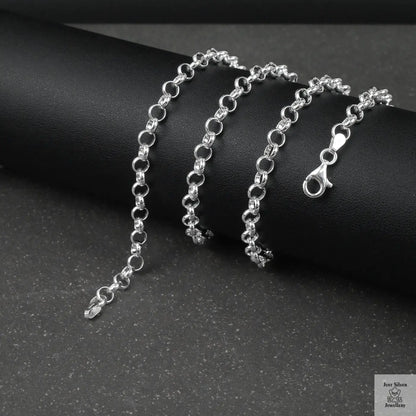 Silver rolo/belcher chain bracelet on a dark surface