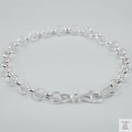 Silver bracelet on a light grey background