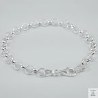 Silver bracelet on a light grey background