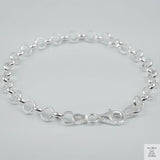 Silver bracelet on a light grey background