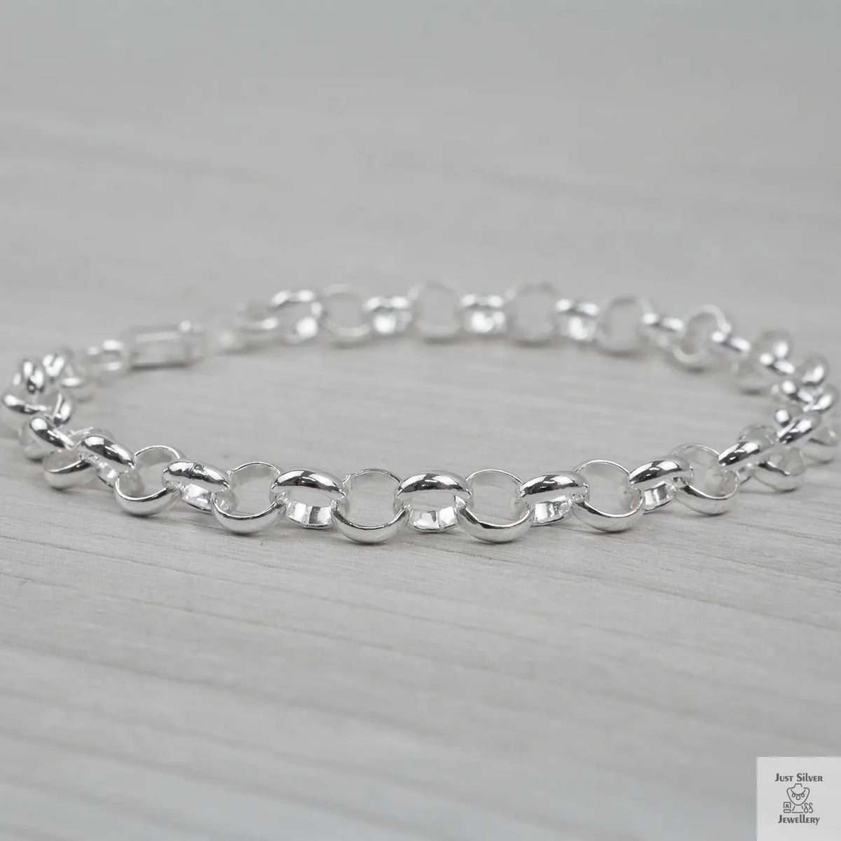 Silver bracelet on a light grey background