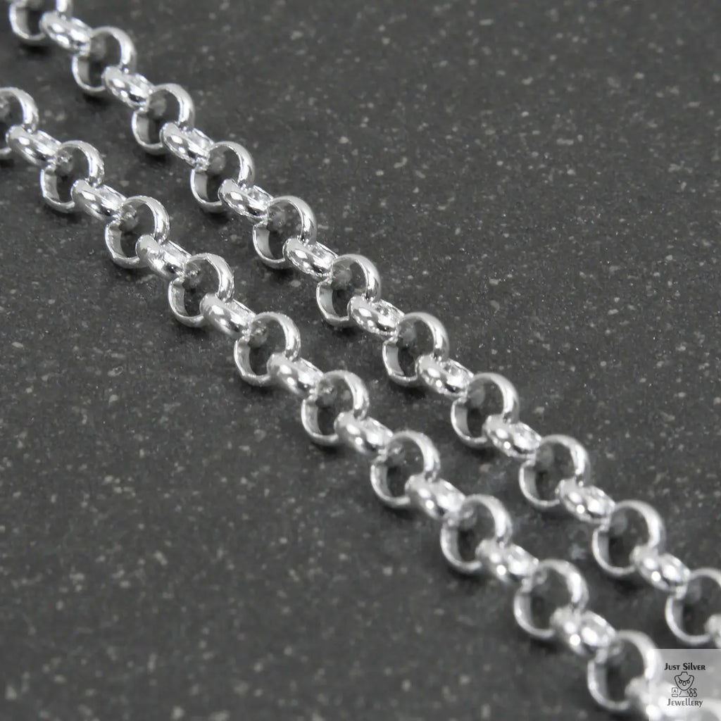 Silver beaded necklace on a light gray background