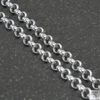 Silver beaded necklace on a light gray background