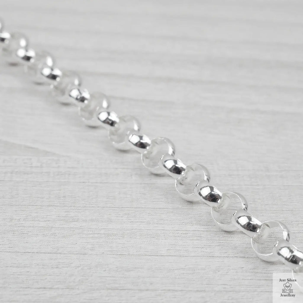 Close-up of a silver bracelet on a light grey background