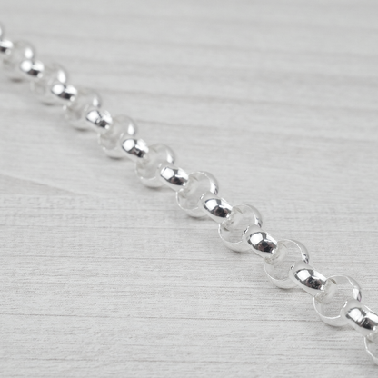 Close-up of a silver bracelet on a light grey background