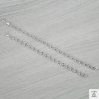 Silver bracelets on a light grey textured surface