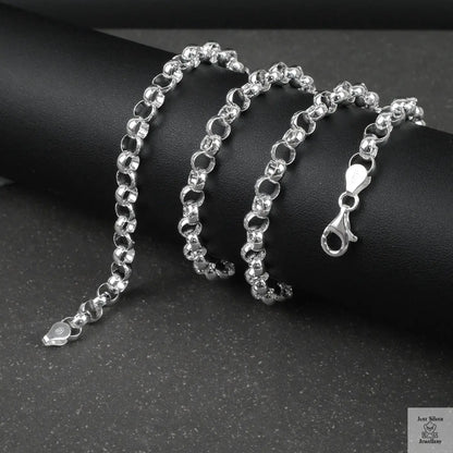 Silver rolo/belcher chain necklace on a dark surface