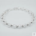 Silver bracelet on a light grey background