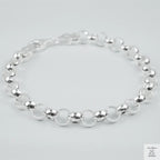Silver bracelet on a light grey background