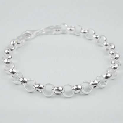 Silver bracelet on a light grey background