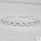 Silver bracelet on a light grey background