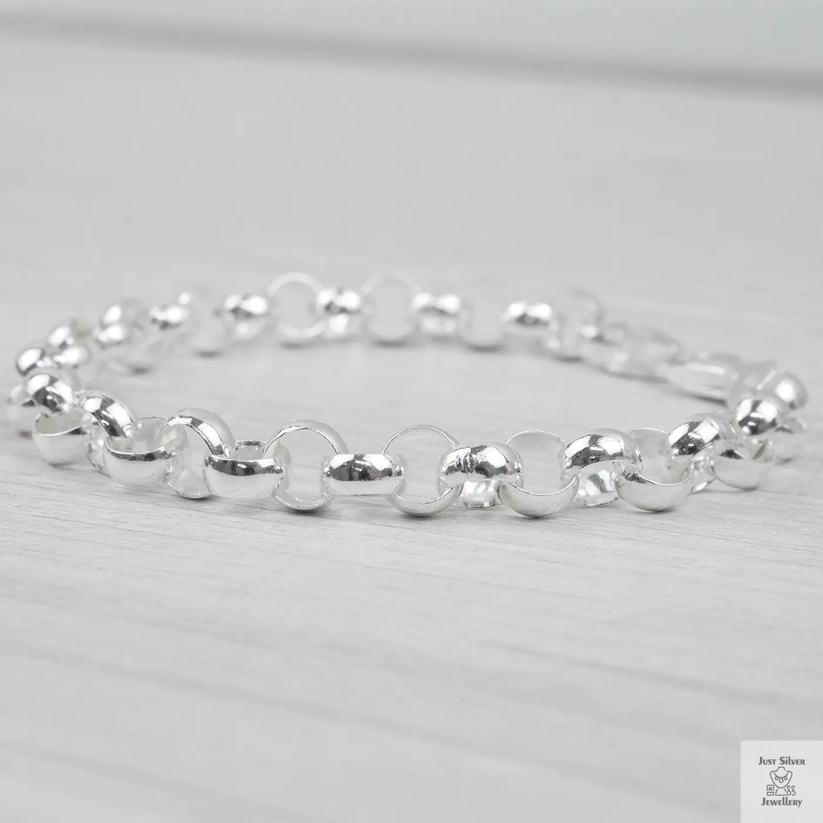 Silver bracelet on a light grey background