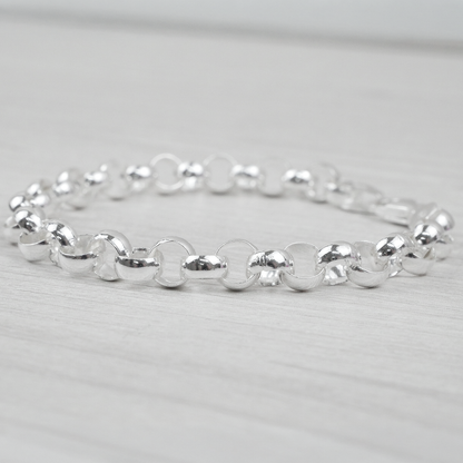 Silver bracelet on a light grey background