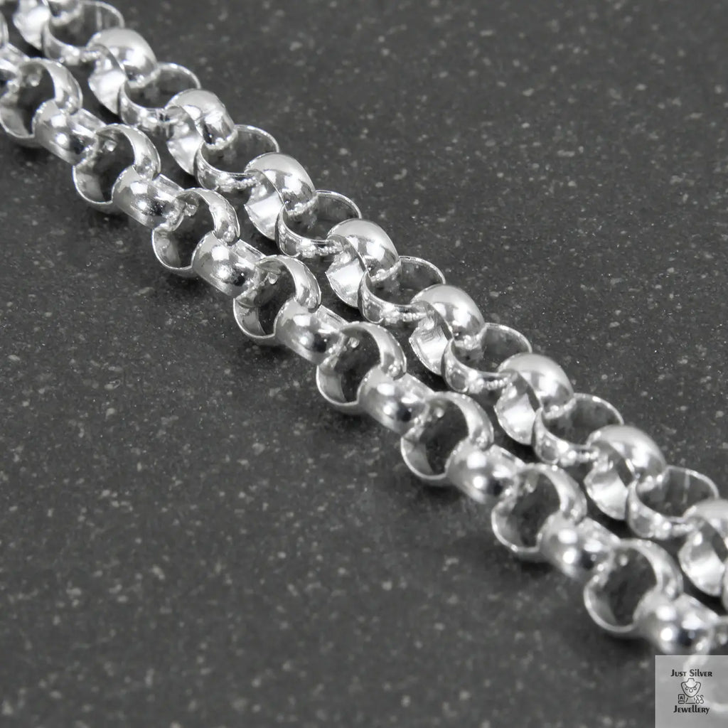 Close-up of a silver beaded necklace on a light gray background