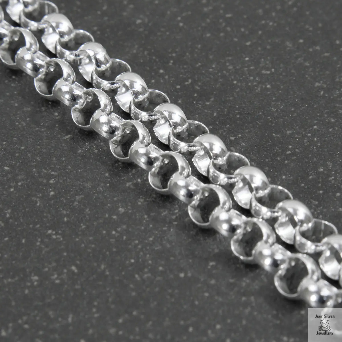 Close-up of a silver beaded necklace on a light gray background