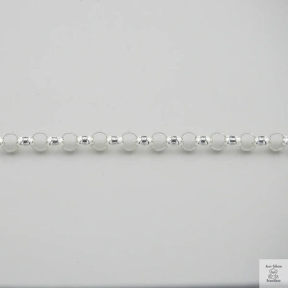 Close-up of a silver beaded necklace on a light gray background