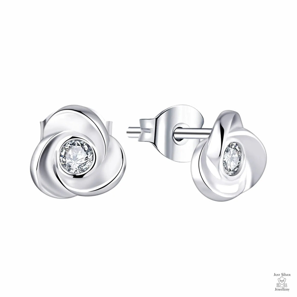 Silver earrings with clear gemstones on a white background