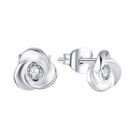 Silver earrings with clear gemstones on a white background
