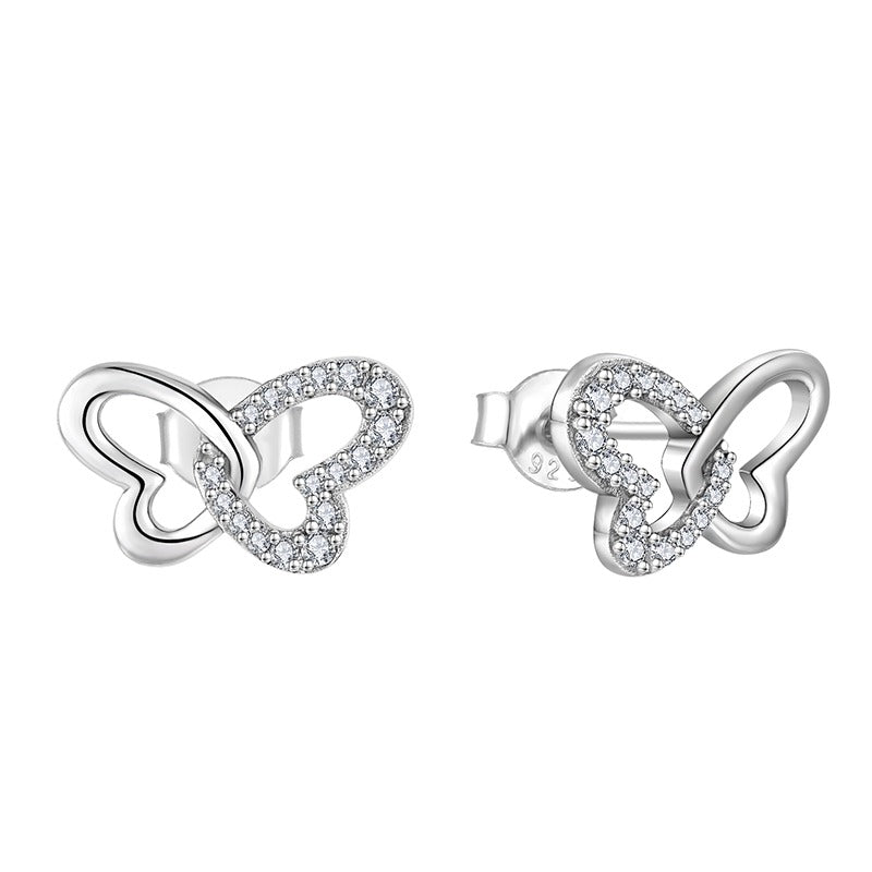Pair of silver butterfly-shaped earrings with clear stones on a white background