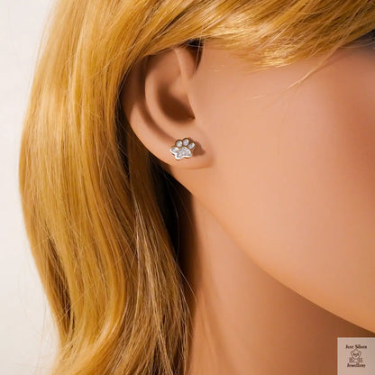 Paw print earring worn on a mannequin with blonde hair