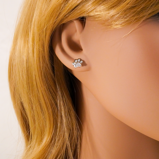 Paw print earring worn on a mannequin with blonde hair