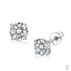 Pair of silver stud earrings with clear natural zircon gemstones on a white background