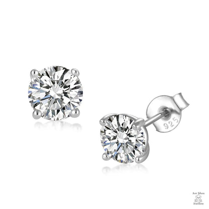 Pair of silver stud earrings with clear natural zircon gemstones on a white background