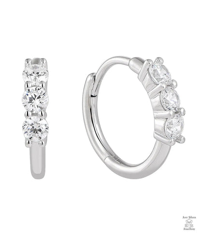 Silver hoop earrings with clear gemstones on a white background