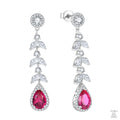 Pair of earrings with red teardrop zircon stones and leaves on a white background