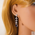 Earring worn on a mannequin with blonde hair against a white background