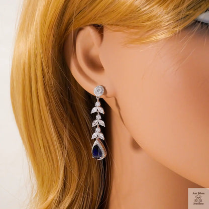 Earring worn on a mannequin with blonde hair against a white background