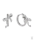 Silver bow-shaped earrings with clear zircon gemstones on a white background
