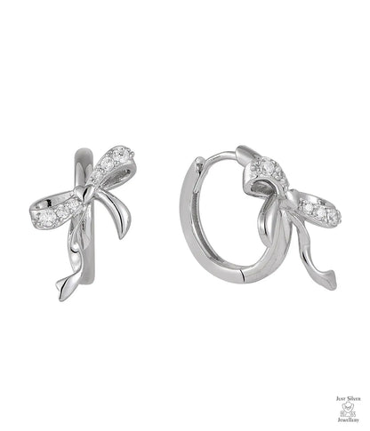 Silver bow-shaped earrings with clear zircon gemstones on a white background