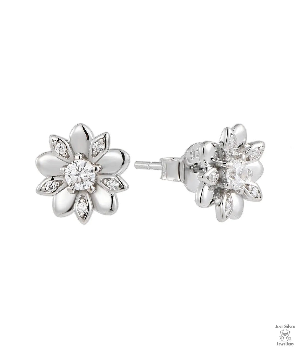 Silver flower-shaped earrings with natural zircon stones on a white background