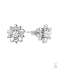 Silver flower-shaped earrings with natural zircon stones on a white background