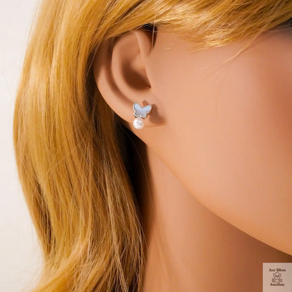 Butterfly earring with pearl detail on a mannequin ear