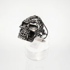 Silver skull ring with intricate design on a white background