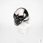 Silver skull ring on a white background