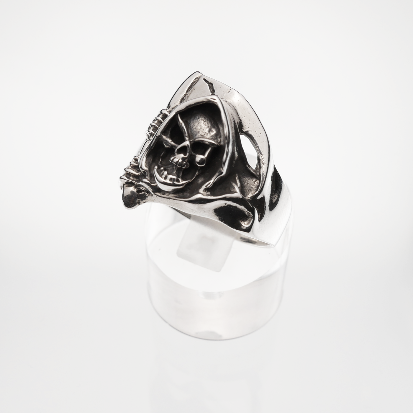 Silver ring with skull design on a white background