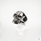 Silver skull ring on a white background