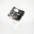 Silver skull and crossbones ring on a white background