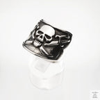 Silver skull and crossbones ring on a white background