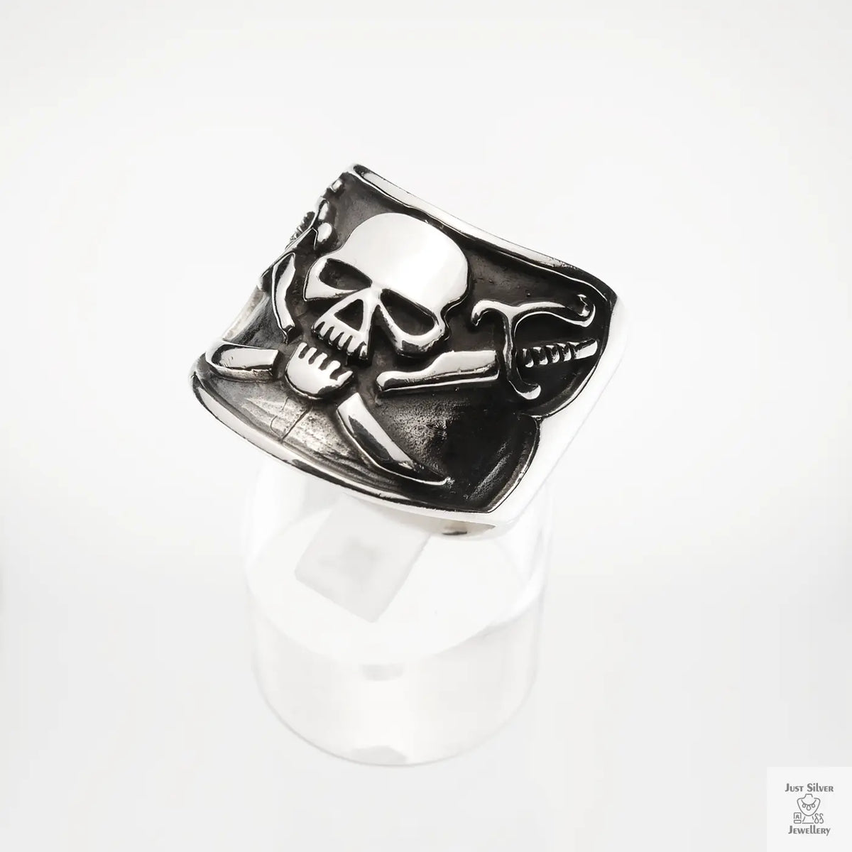 Silver skull and crossbones ring on a white background