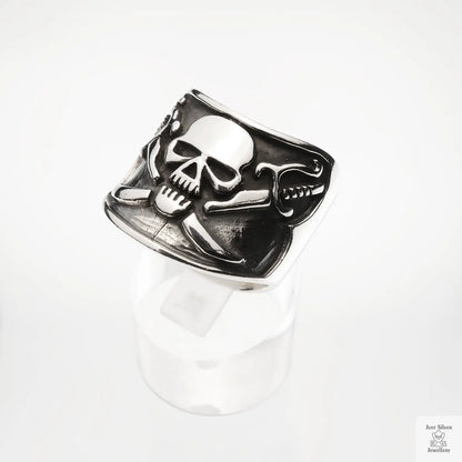 Silver skull and crossbones ring on a white background