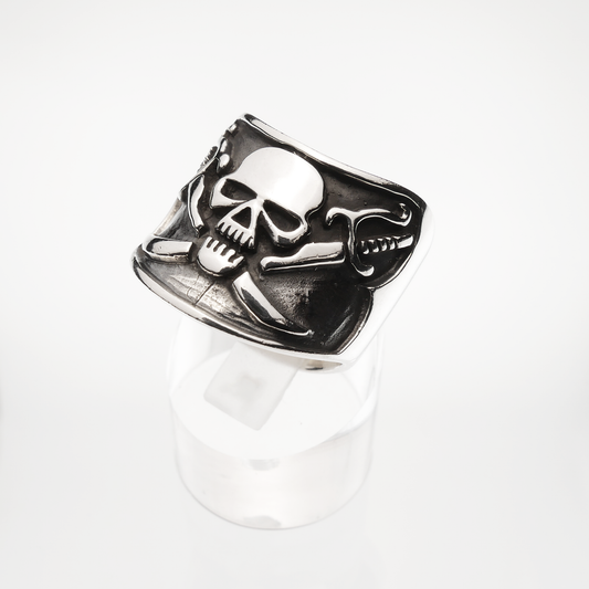 Silver skull and crossbones ring on a white background