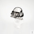Silver skull-shaped ring on a white background
