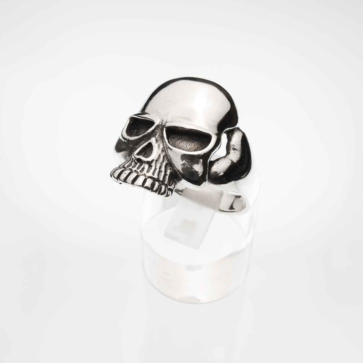 Silver skull-shaped ring on a white background