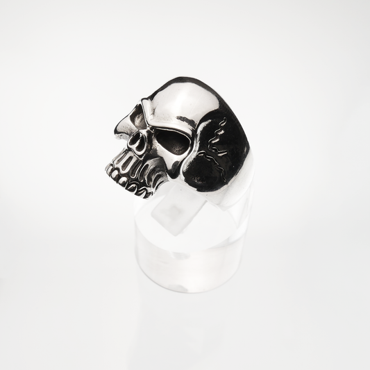 Skull-shaped silver ring on a white background