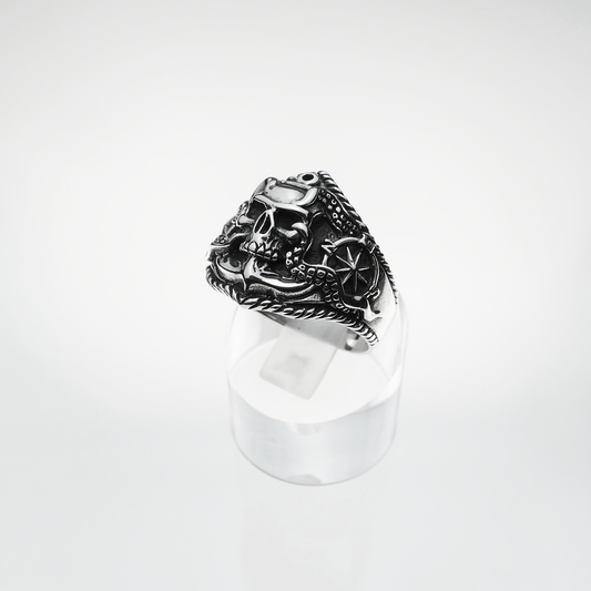Silver ring with intricate design on a white background