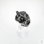 Silver skull ring with red stones on a white background